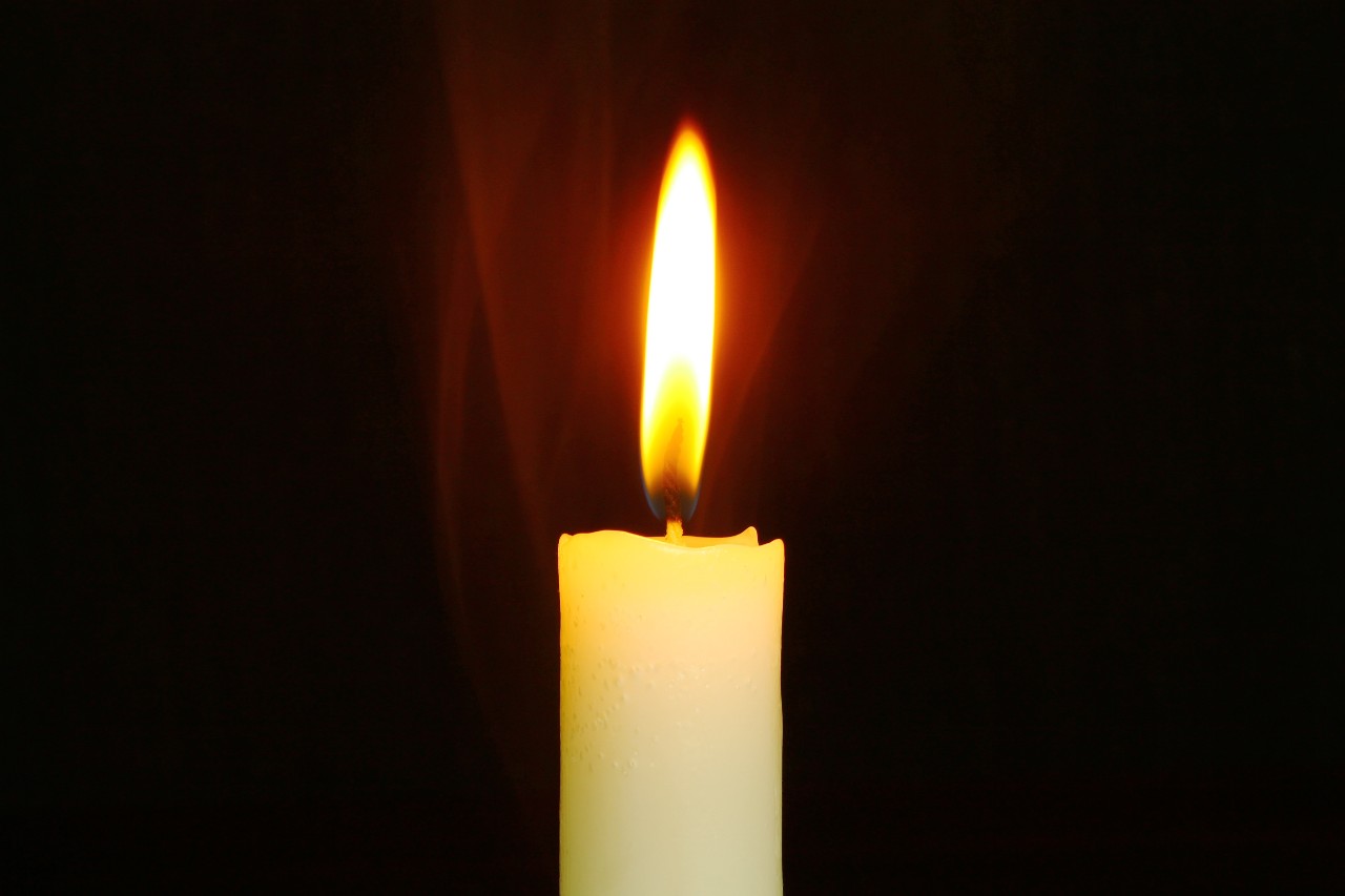 Candle glowing in the dark