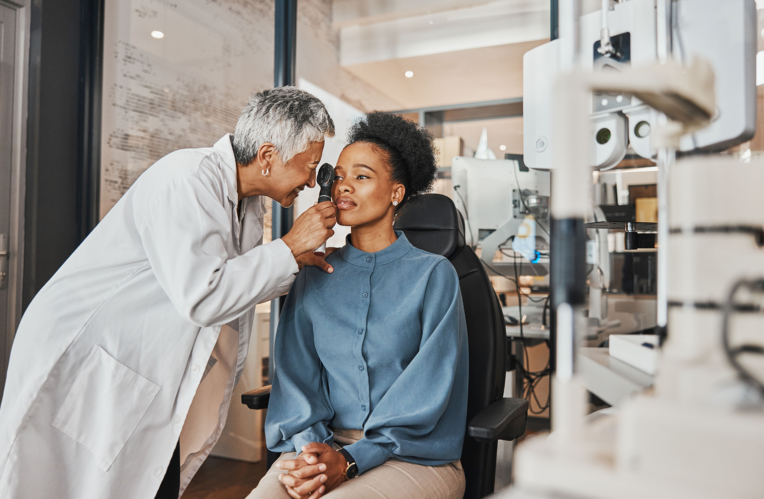 An eye care provider examines a patient's eyes.