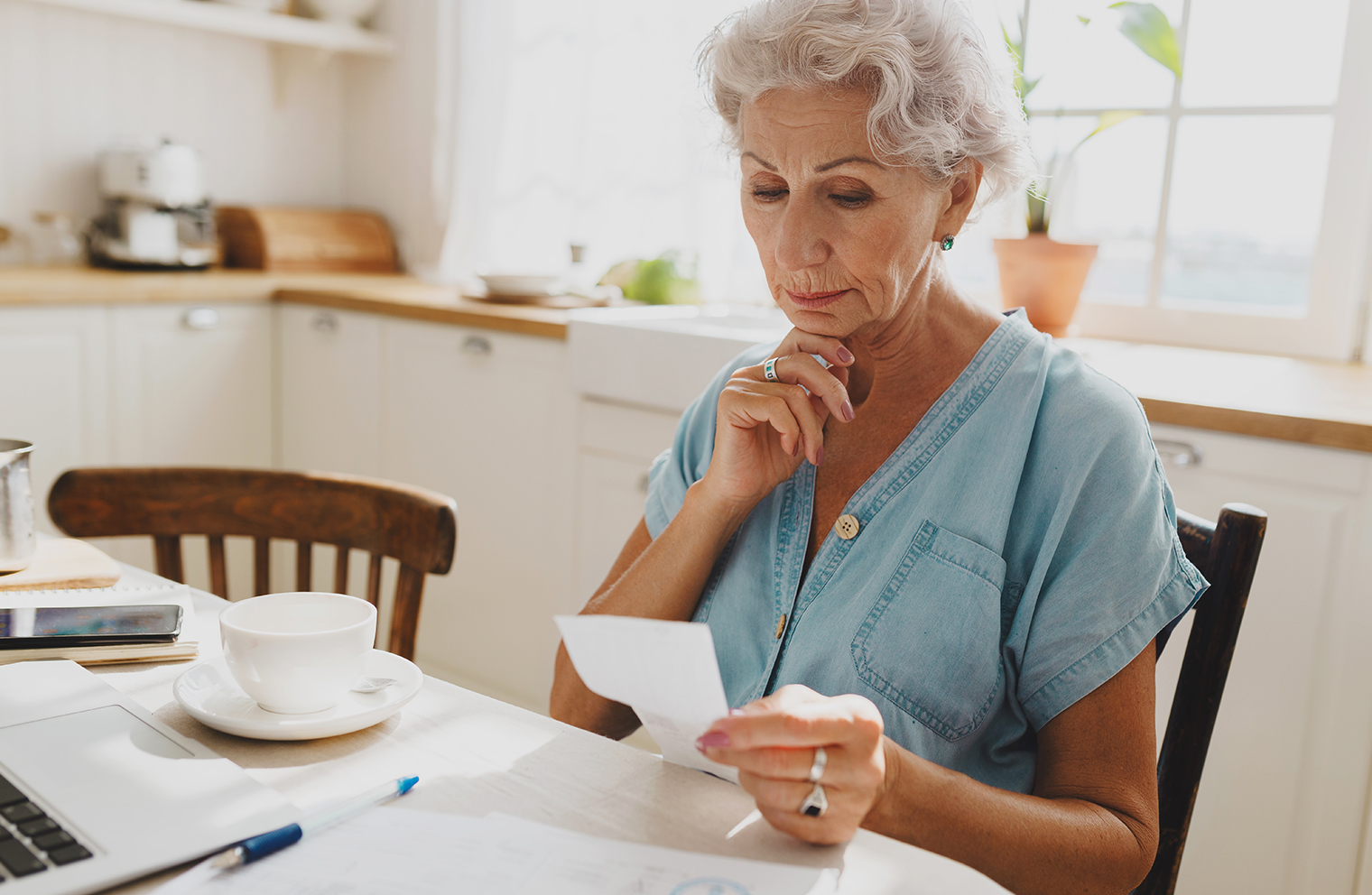 A woman looks at medical bills. 