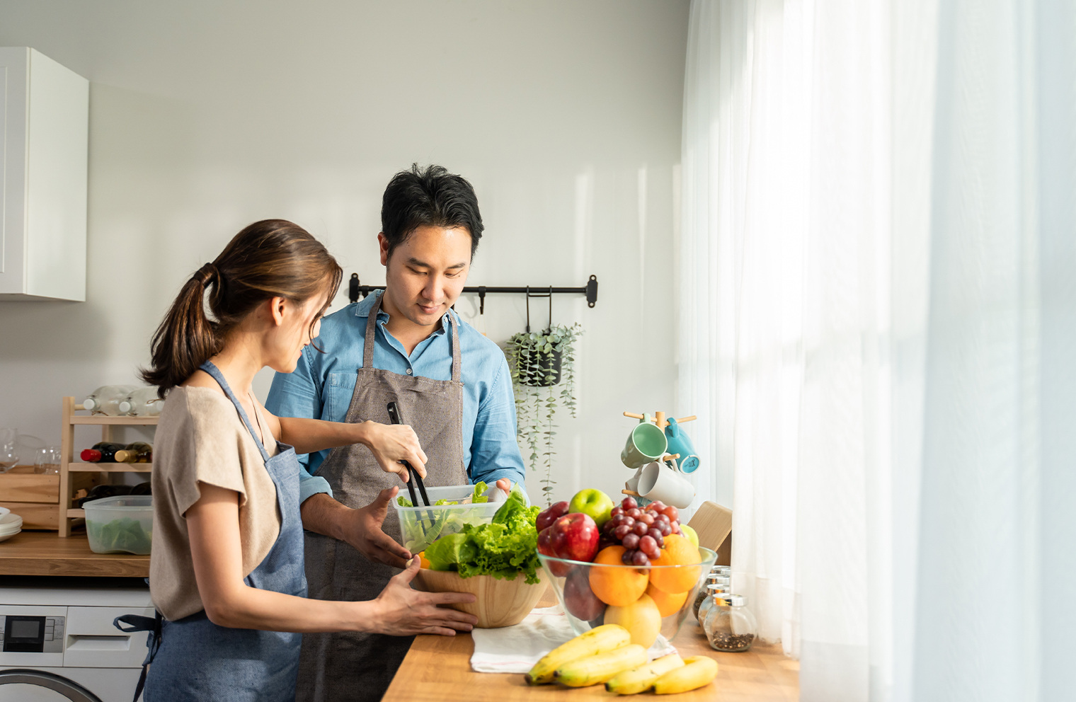 A man and woman prepare a healthy fruits and vegetables in the kitchen.