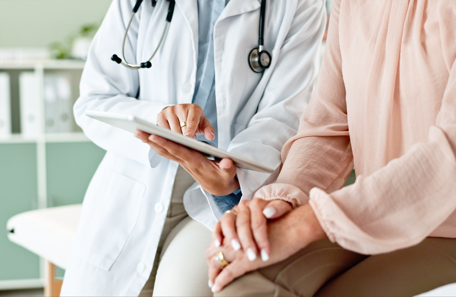 An emergency care provider holds a clipboard as they explain care options to a patient.