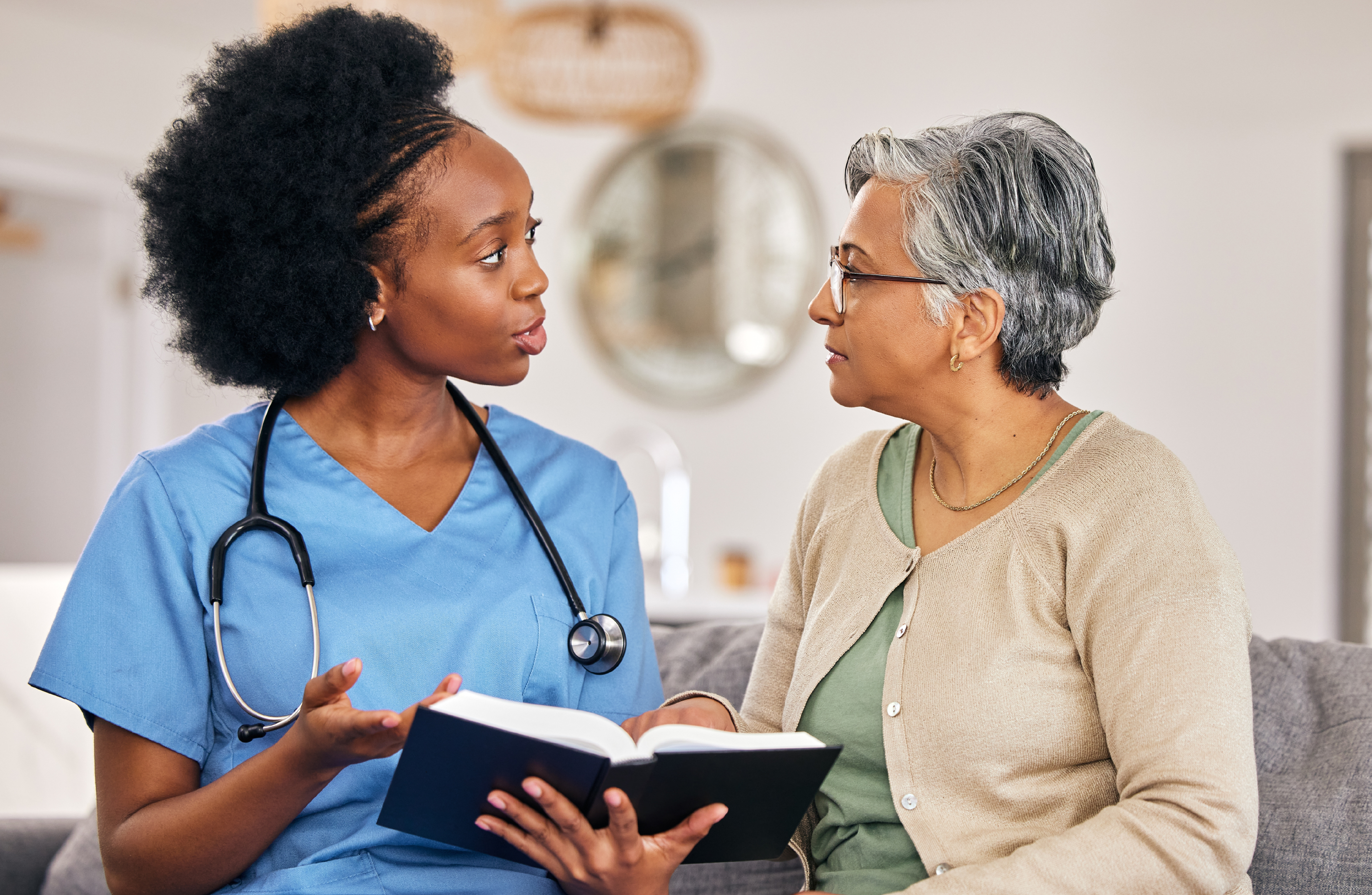 A health care professional speaks with a patient. 