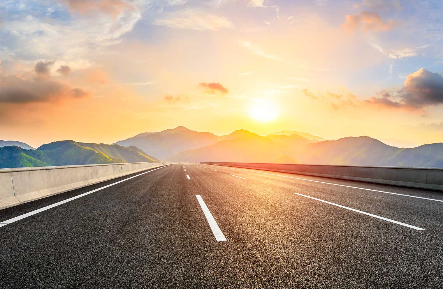 Empty stretch of highway at sunset