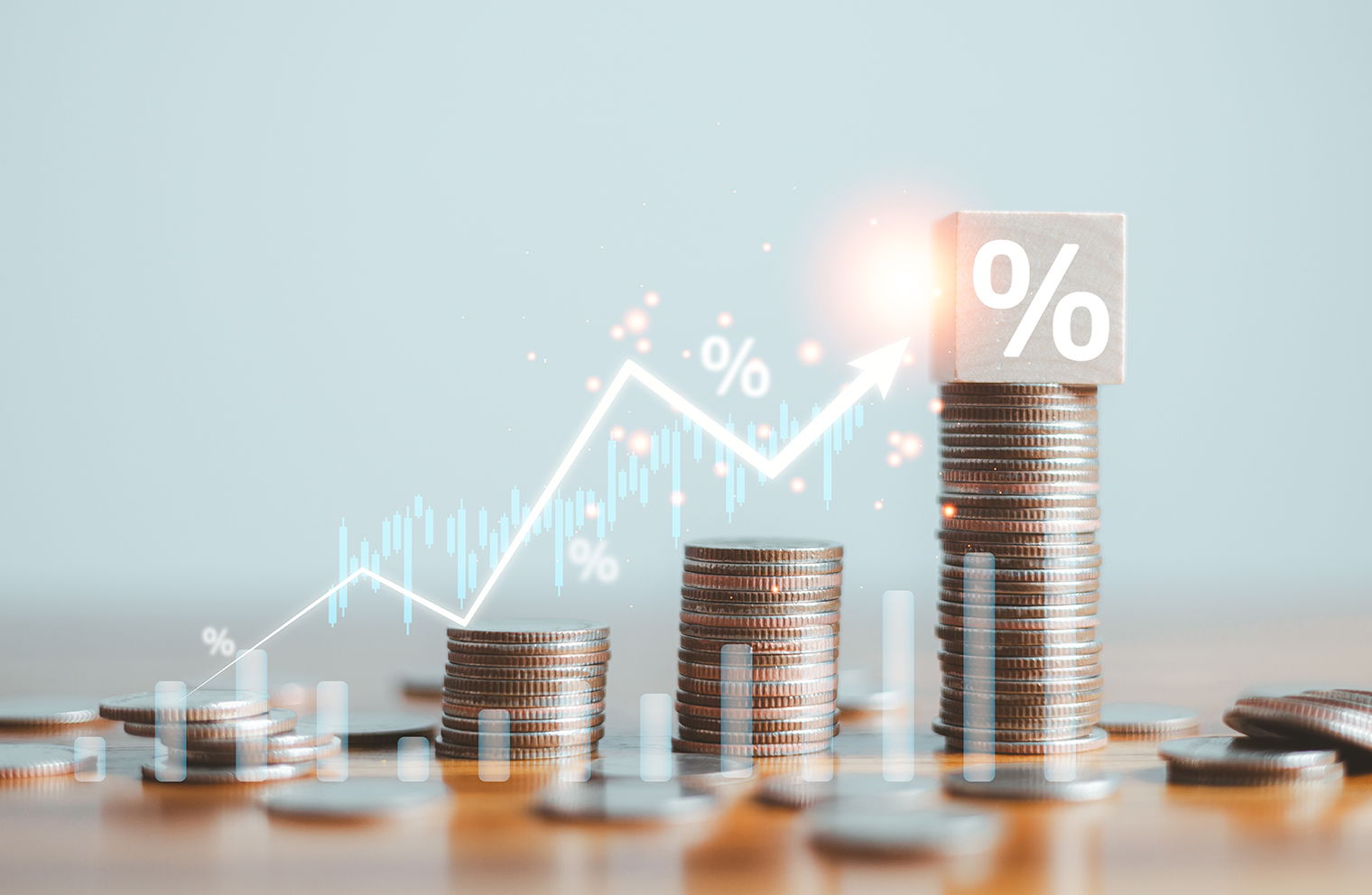 A stack of coins overlaid by the image of a graph denoting percentage points