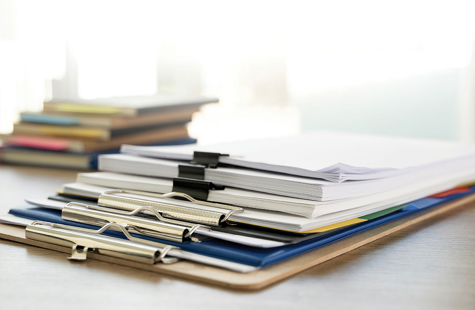 Image showing a stack of clipboards on top of desk.