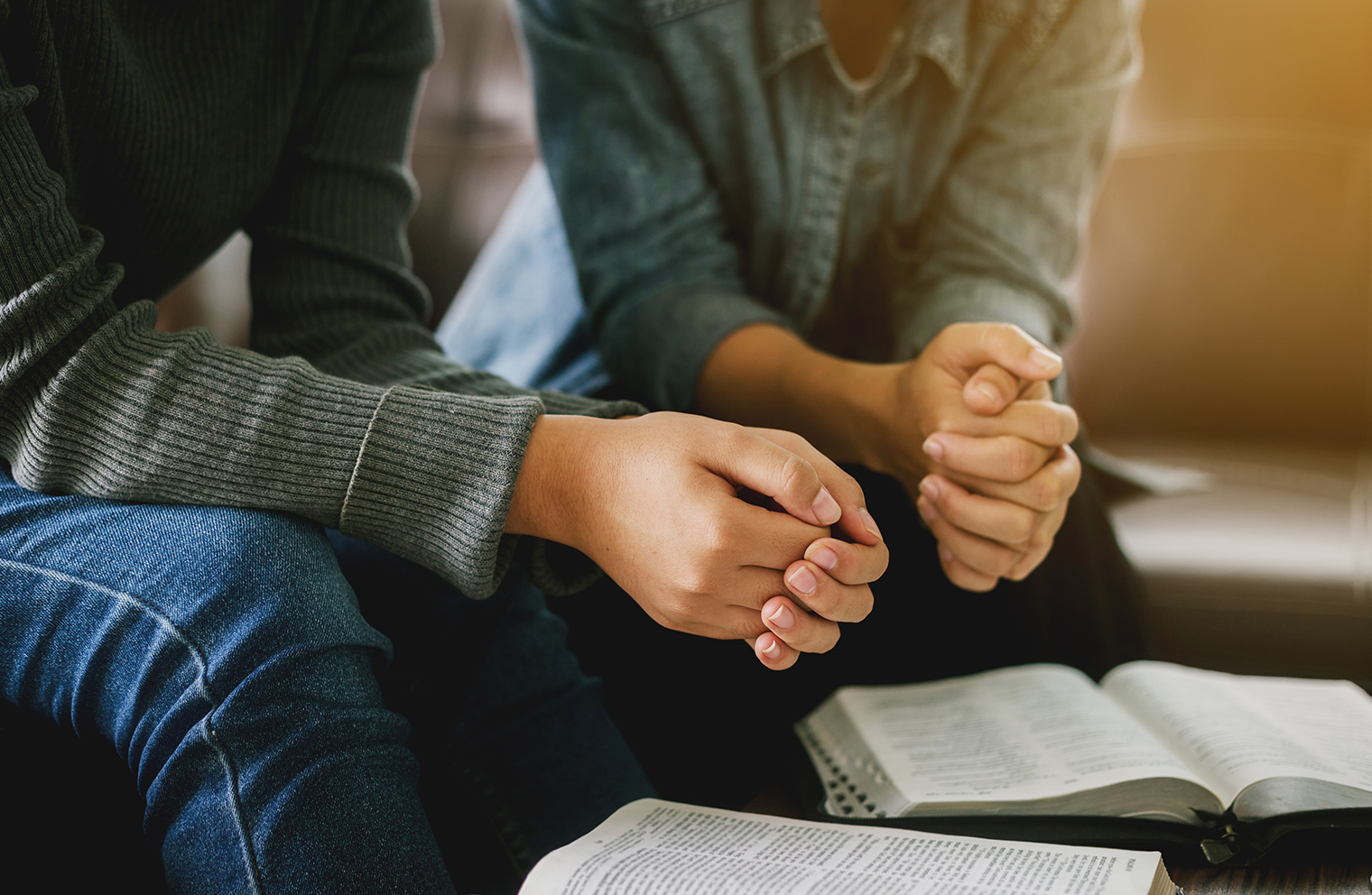 Two people reading Bibles together.