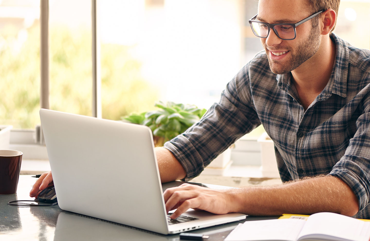 Image of man smiling down at laptop