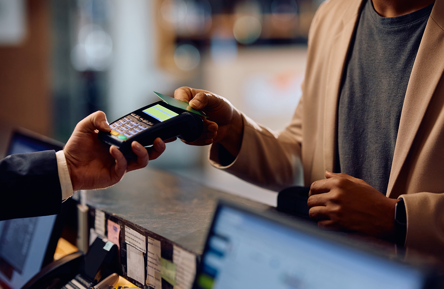 A man scanning his credit card for a transaction.